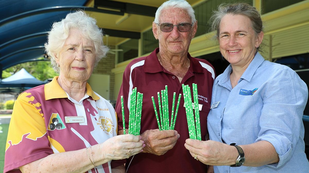 Bundaberg Bowls Club members Marcia Nicol, John Clough and Burnett LMAC chair Sue SargentSue Sargent with the #LessIsMore paper straws.