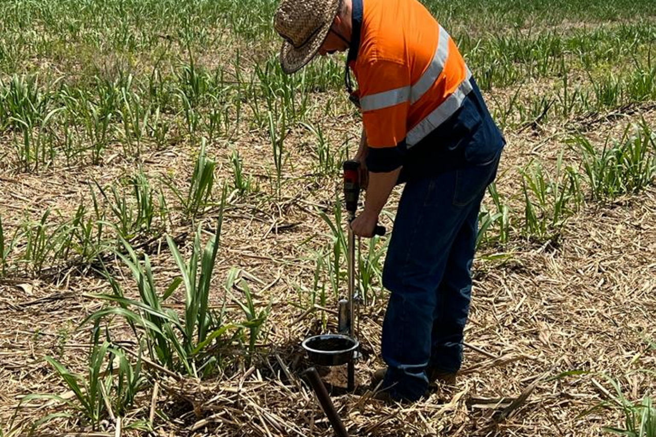 Bryce Jackson collects soil samples on his farm. Credit: Liquaforce.