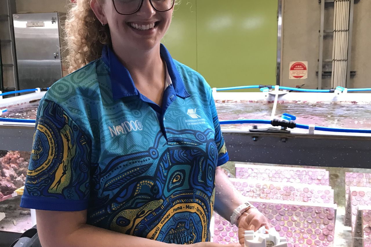 Ecologist Dr Carly Randall, AIMS, with a specially designed device to settle and grow coral. 