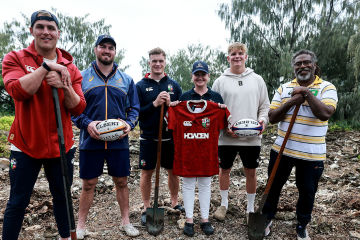 Lions and Wallabies players planting trees on Lady Elliot Island.
