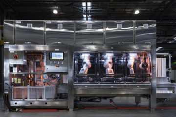 Machine One: a semi-automated coral-seeding system is a large metallic machine with various robotic arms. 